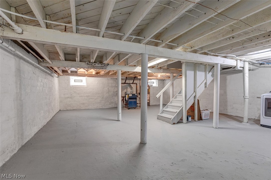 2972 Yorkshire Road Cleveland Heights, OH 44118 - Photo 35 of 44 Spacious lower level featuring painted concrete floors, exposed ceiling joists, and a utility area