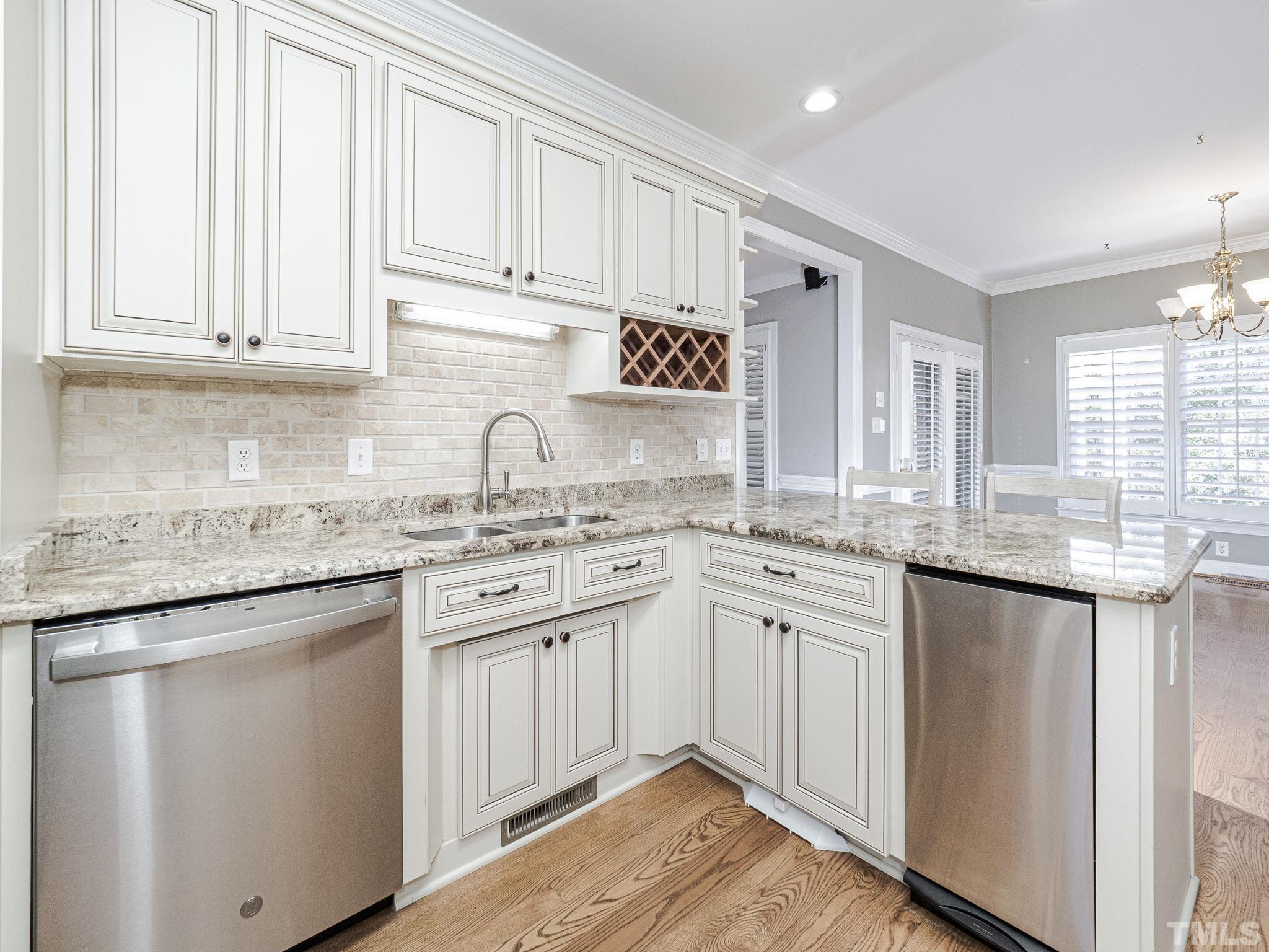 726 Pope Lake Road Angier, NC 27501 - Photo 11 of 29 a kitchen with granite countertop white cabinets and white appliances