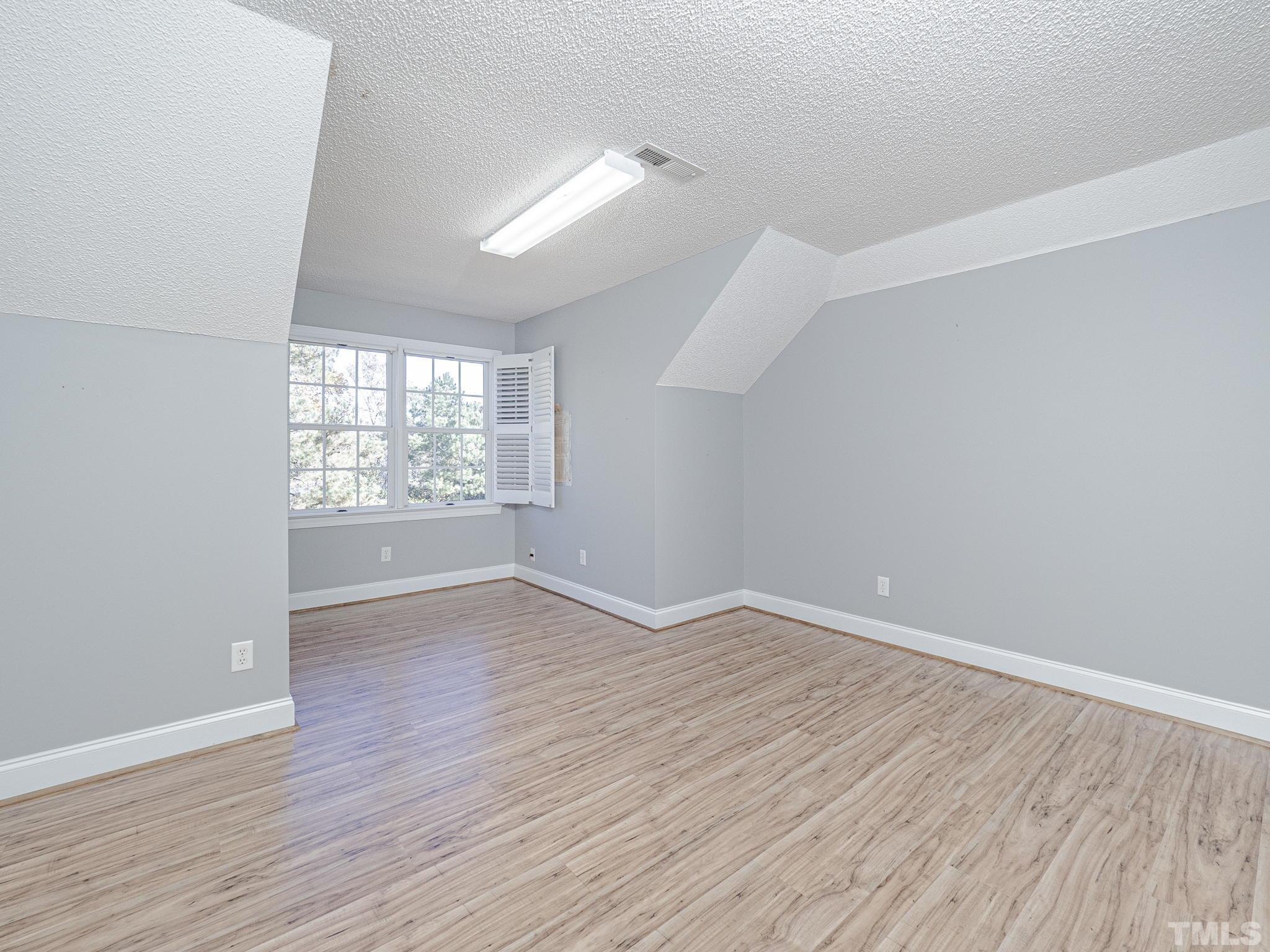 726 Pope Lake Road Angier, NC 27501 - Photo 22 of 29 wooden floor in an empty room with a window
