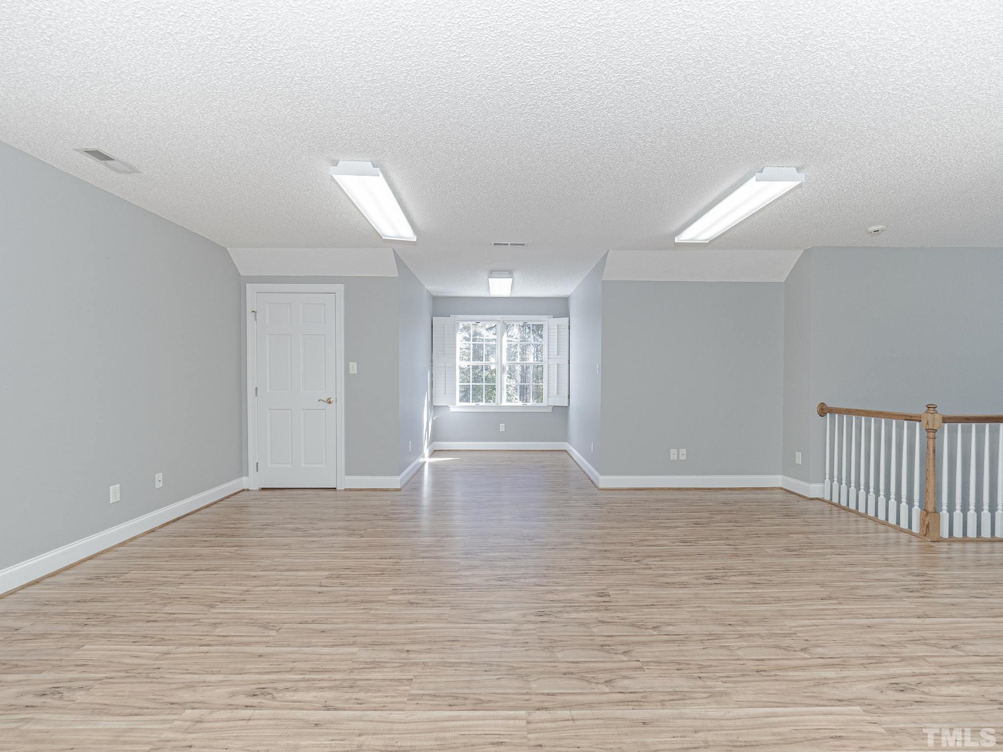 726 Pope Lake Road Angier, NC 27501 - Photo 29 of 29 a view of an empty room with window and wooden floor