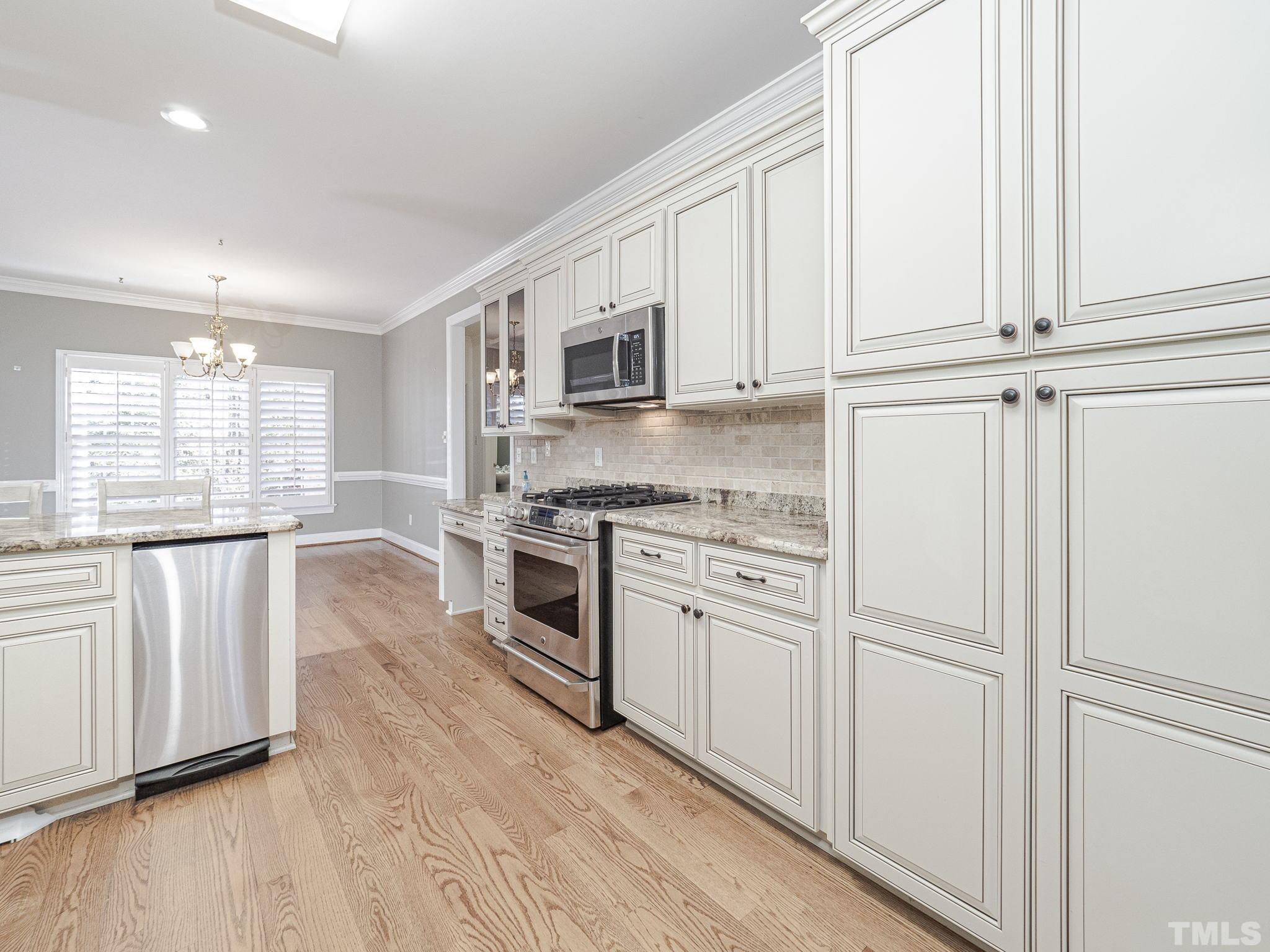 726 Pope Lake Road Angier, NC 27501 - Photo 10 of 29 a kitchen with white cabinets and appliances