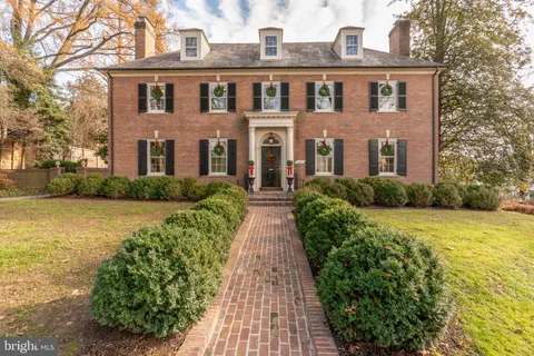 a living room with furniture a rug and a fireplace