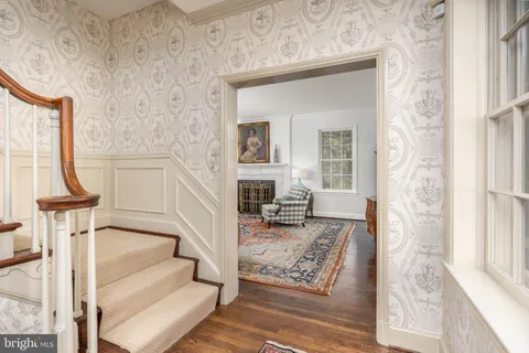 a living room with furniture and a book shelf