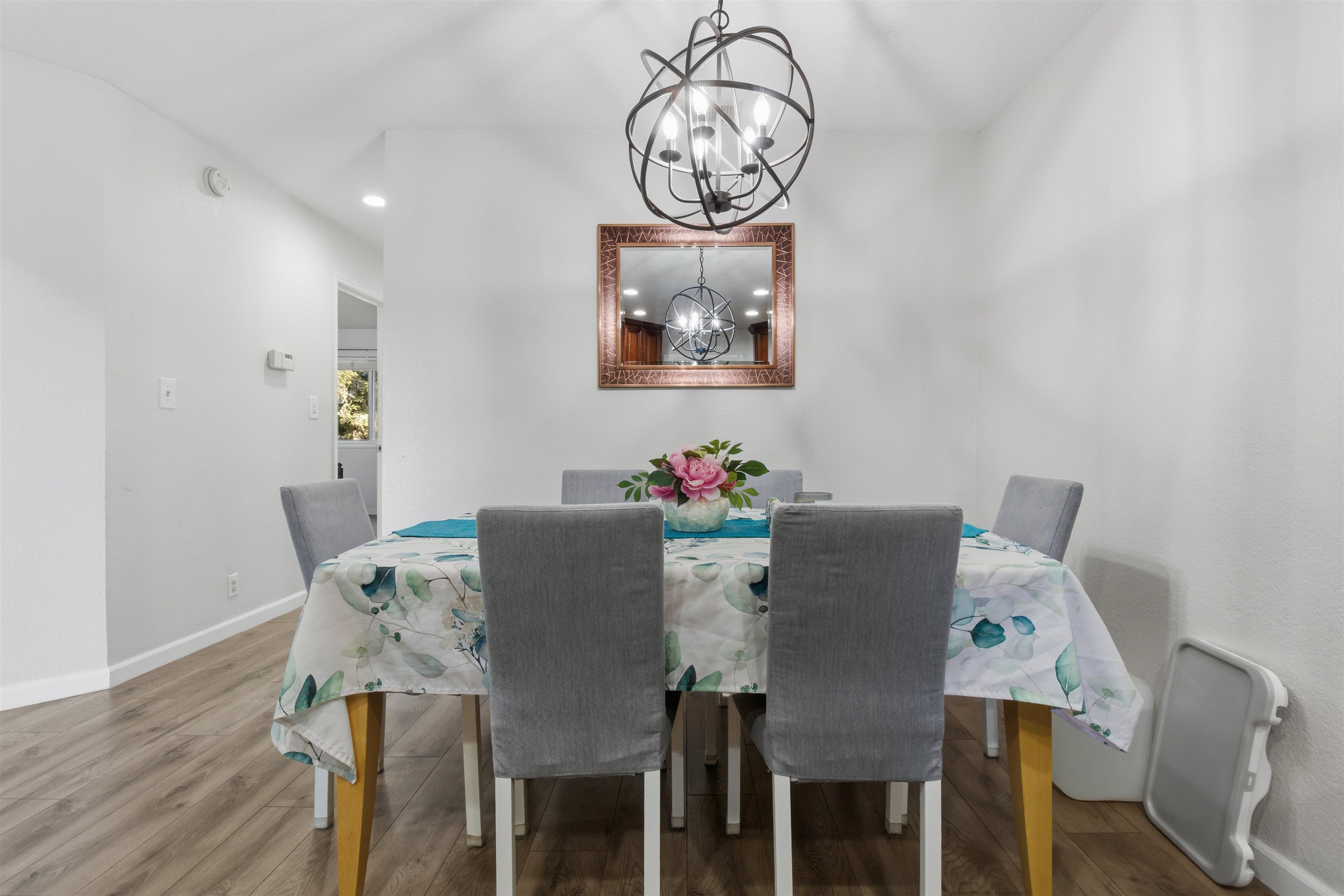 370 Sequim Common Fremont, CA 94539 - Photo 22 of 28 a view of a dining room with furniture wooden floor and a chandelier