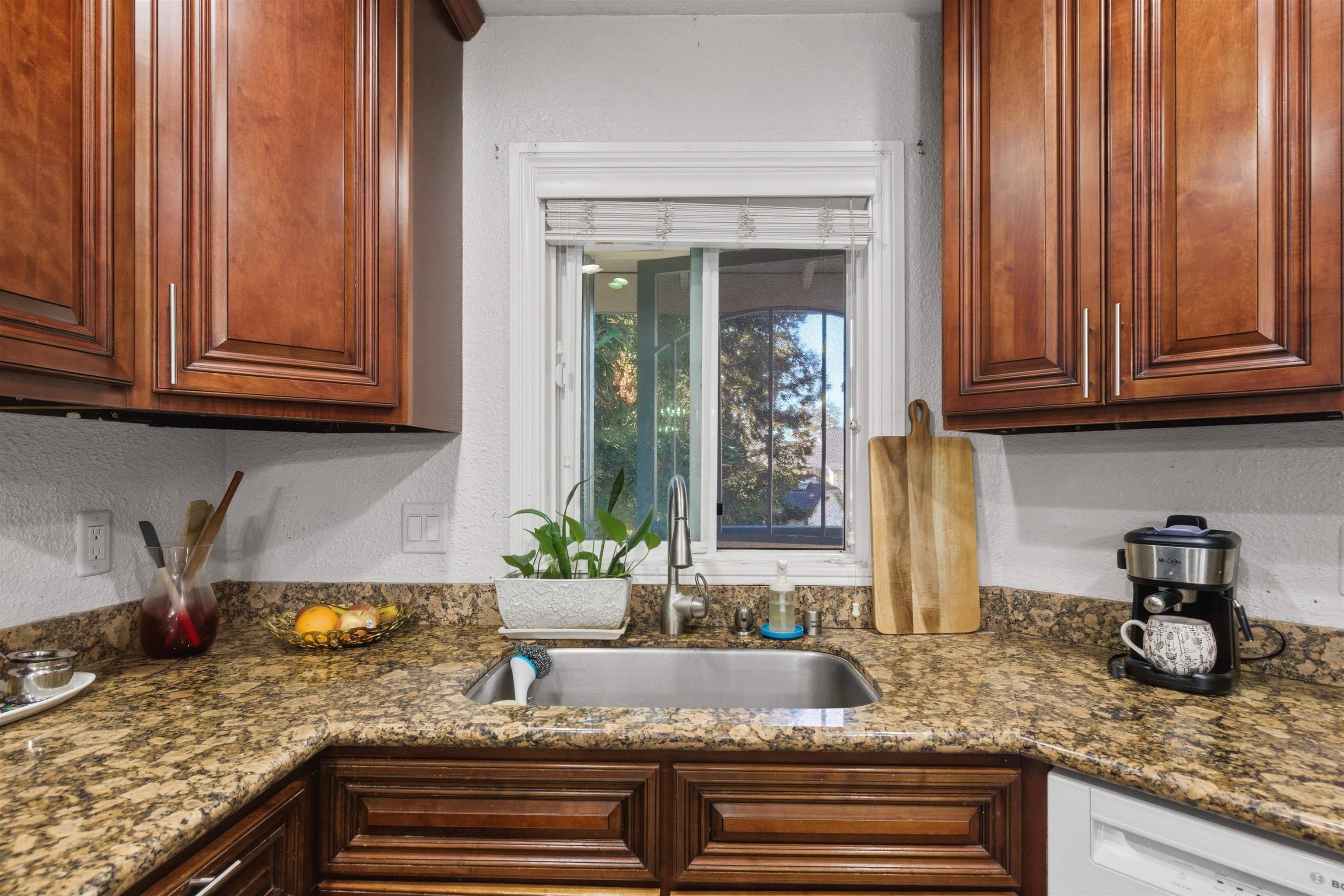370 Sequim Common Fremont, CA 94539 - Photo 24 of 28 a kitchen with granite countertop stainless steel appliances granite countertop a sink and white cabinets