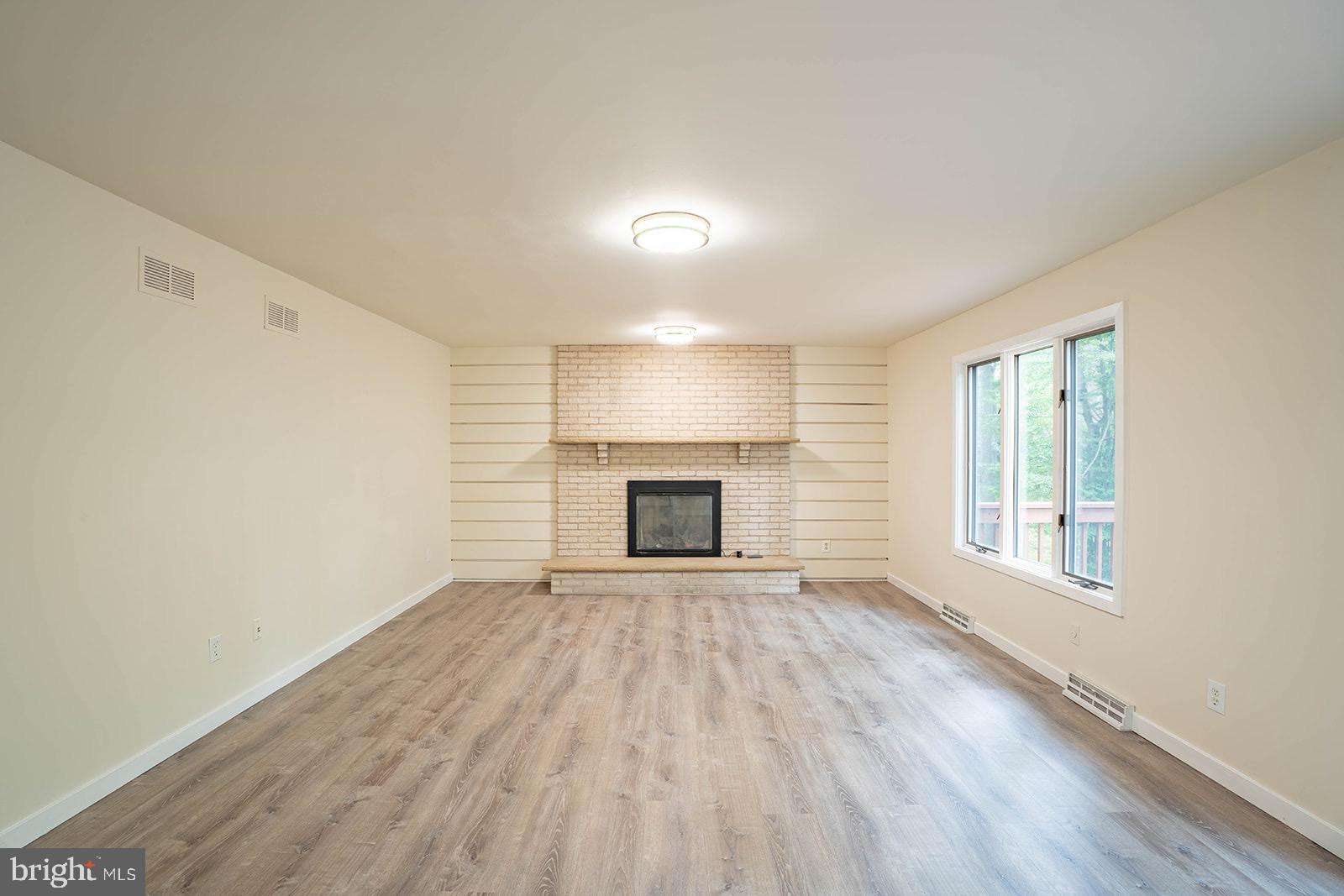 491 Kings Road Yardley, PA 19067 - Photo 22 of 52 a view of an empty room with a fireplace and a window