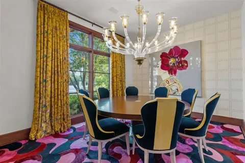a view of a dining room with furniture and chandelier