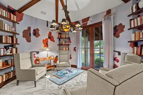 a living room with furniture and a book shelf