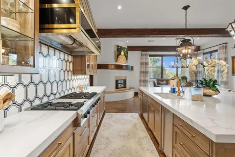 a kitchen with stainless steel appliances granite countertop a stove and a sink