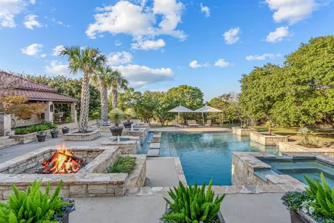 a view of a swimming pool with outdoor seating and plants