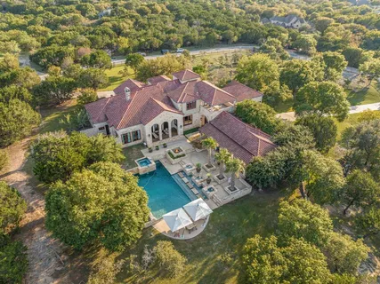 an aerial view of house with yard swimming pool and outdoor seating