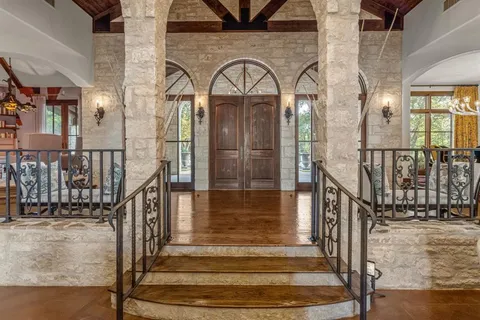 a view of staircase with lots of frames on wall and windows