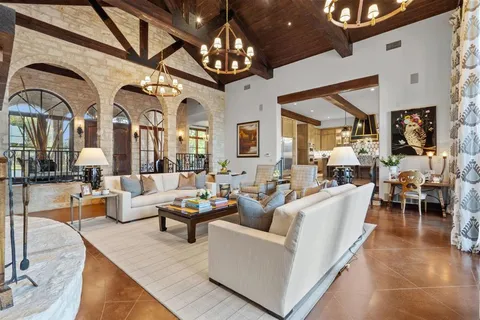 a living room with lots of furniture and a chandelier