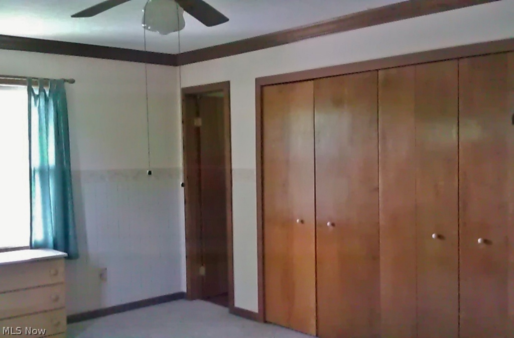 2920 Baughman Road Clinton, OH 44216 - Photo 19 of 25 Large master bedroom with entrance to the bath, double closets, crown molding and ceiling fan.