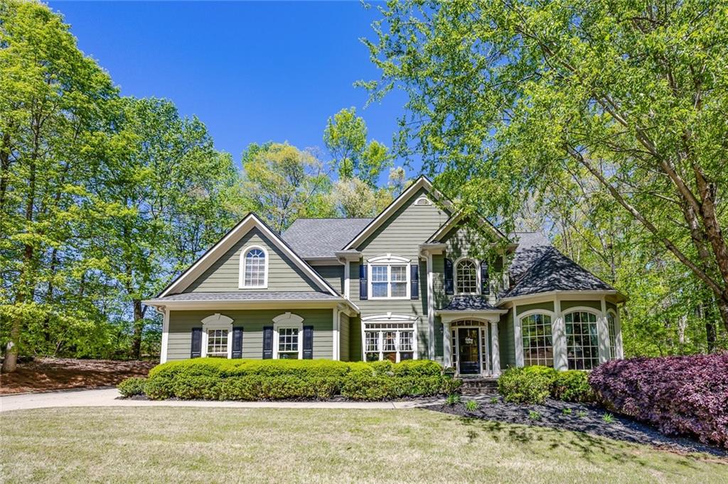 a front view of a house with a garden