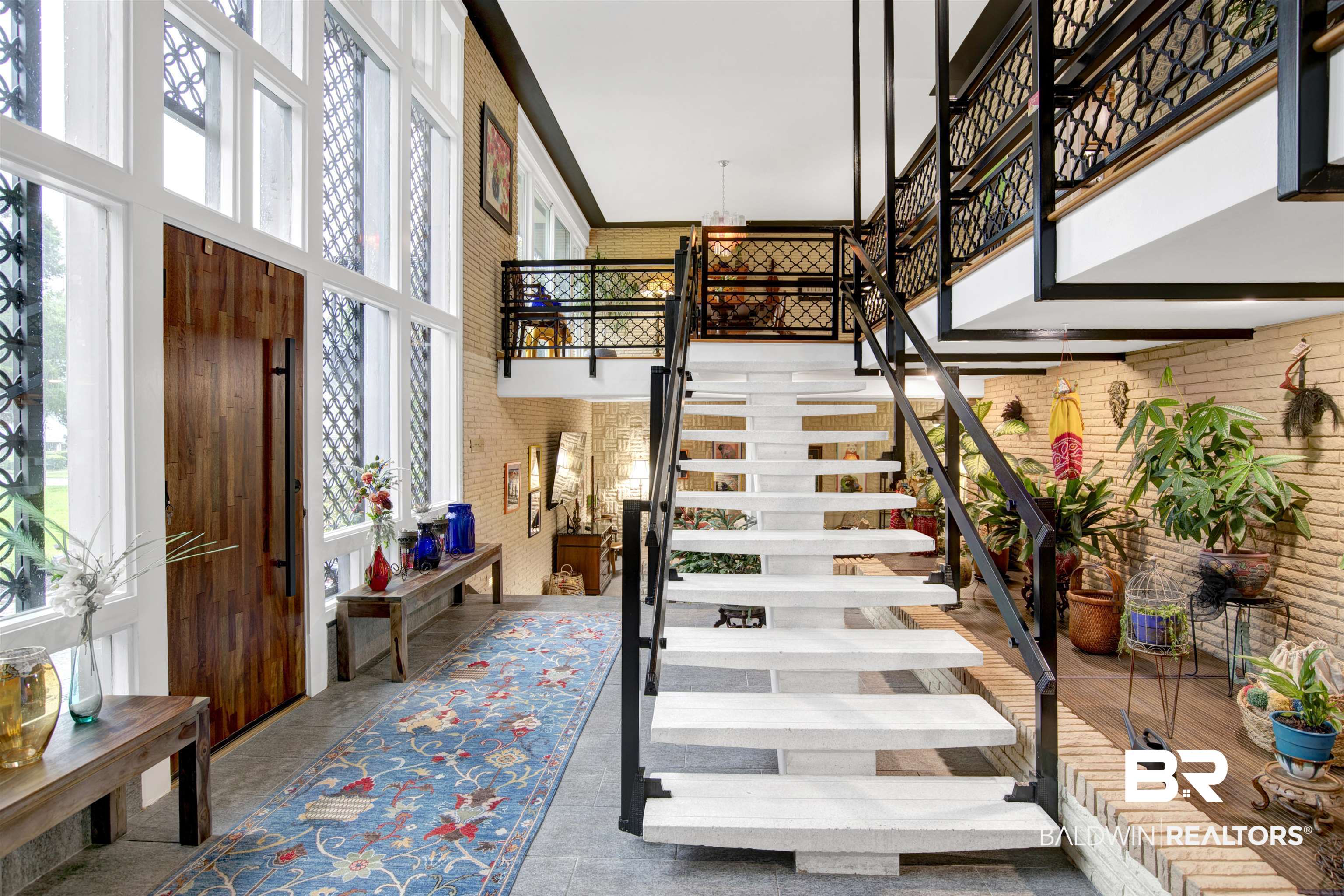 809 Bernard Circle Mobile, AL 36693 - Photo 6 of 75 Two-story entry featuring white floating staircase, black metal railings, and a two-story window wall