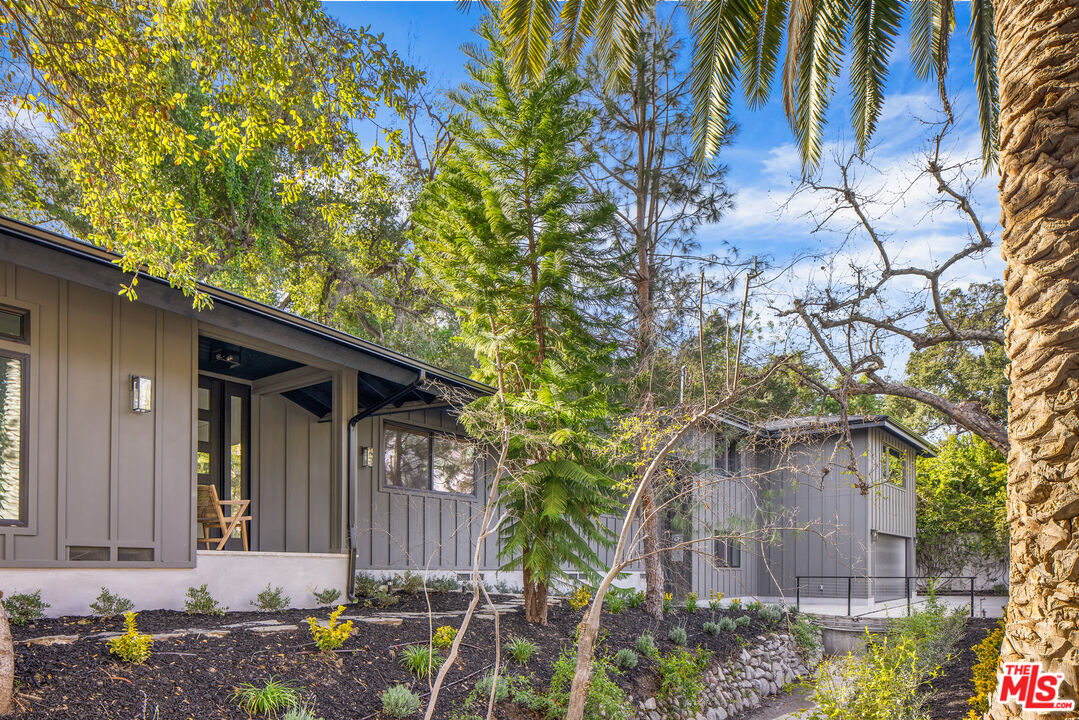 17140 Rancho Street Encino, CA 91316 - Photo 1 of 28 a front view of a house with garden