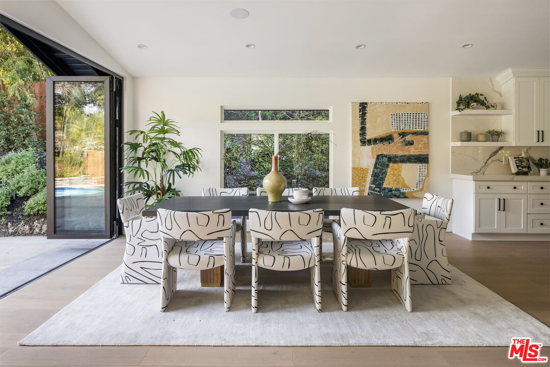 17140 Rancho Street Encino, CA 91316 - Photo 11 of 28 a dining room with furniture and wooden floor