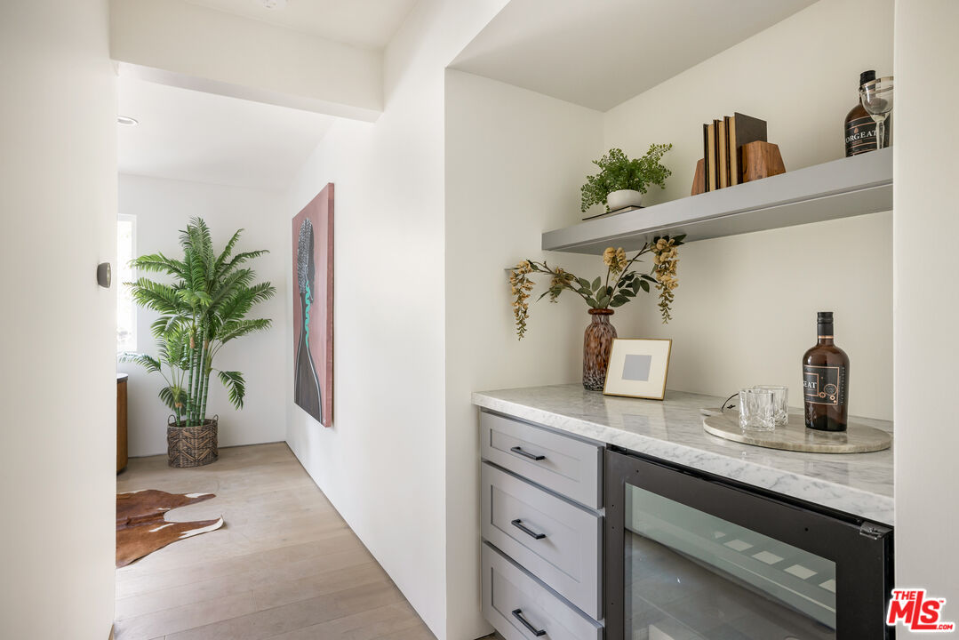 17140 Rancho Street Encino, CA 91316 - Photo 14 of 28 a kitchen with a potted plant on the counter and cabinets