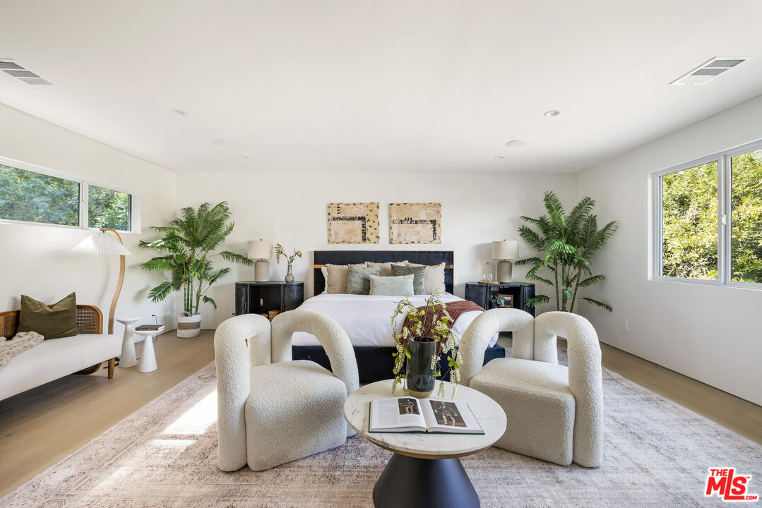 17140 Rancho Street Encino, CA 91316 - Photo 16 of 28 a living room with furniture potted plant and a large window