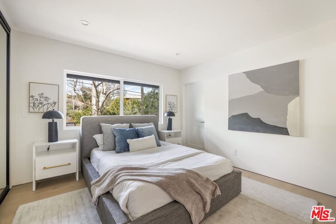 17140 Rancho Street Encino, CA 91316 - Photo 19 of 28 a bedroom with a large bed and a window