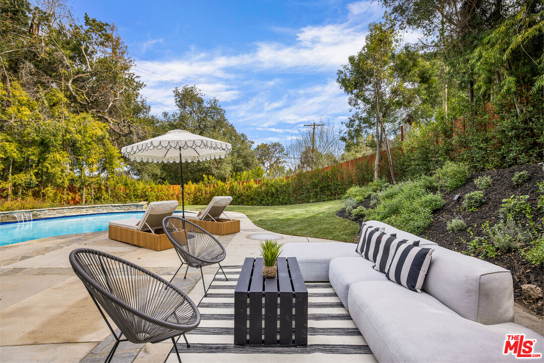 17140 Rancho Street Encino, CA 91316 - Photo 24 of 28 a view of a patio with couches chairs and a table and chairs