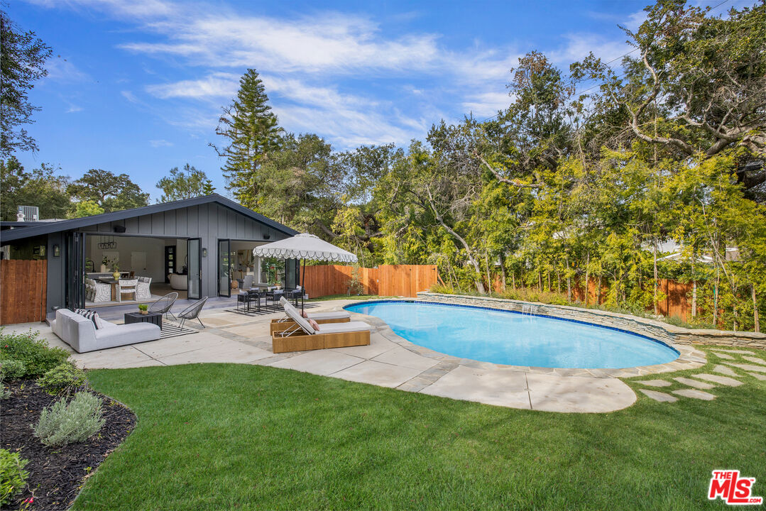 17140 Rancho Street Encino, CA 91316 - Photo 27 of 28 a view of a house with backyard porch and sitting area