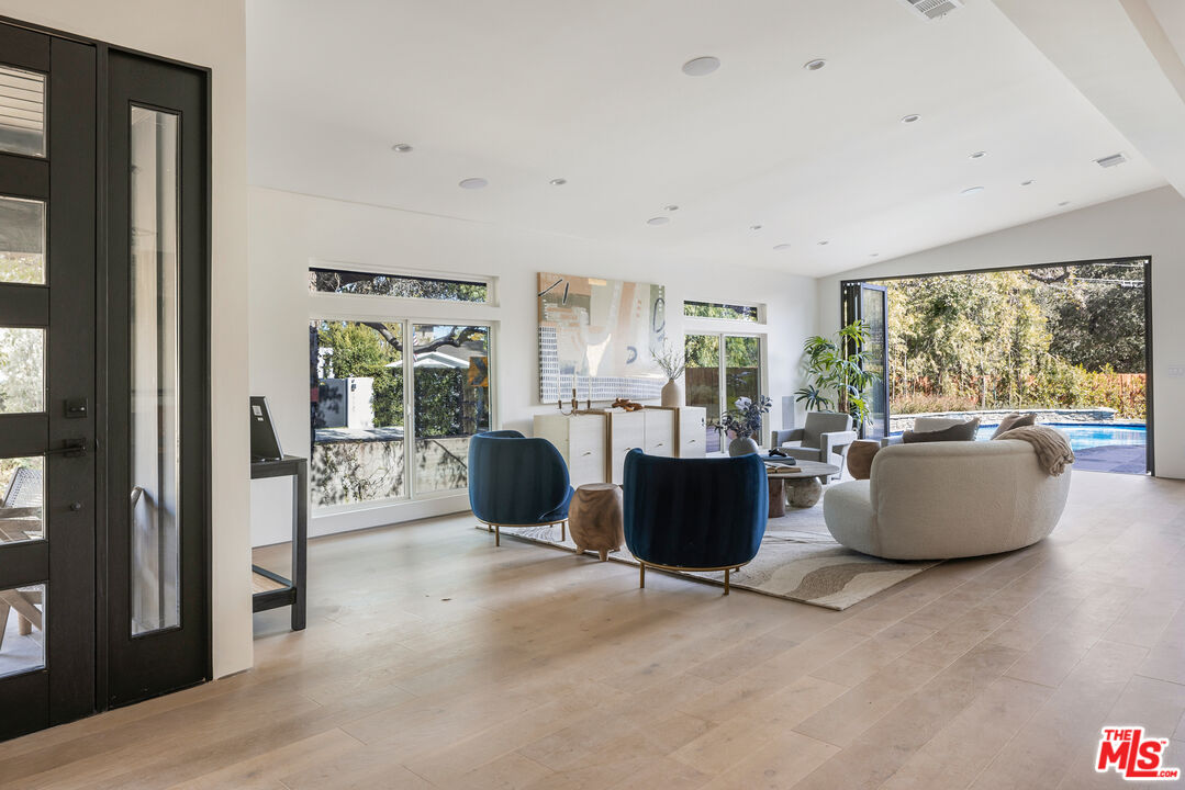 17140 Rancho Street Encino, CA 91316 - Photo 5 of 28 a living room with furniture and a flat screen tv