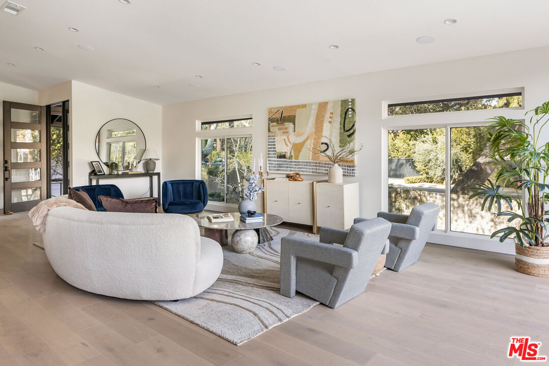 17140 Rancho Street Encino, CA 91316 - Photo 7 of 28 a living room with furniture and a large window