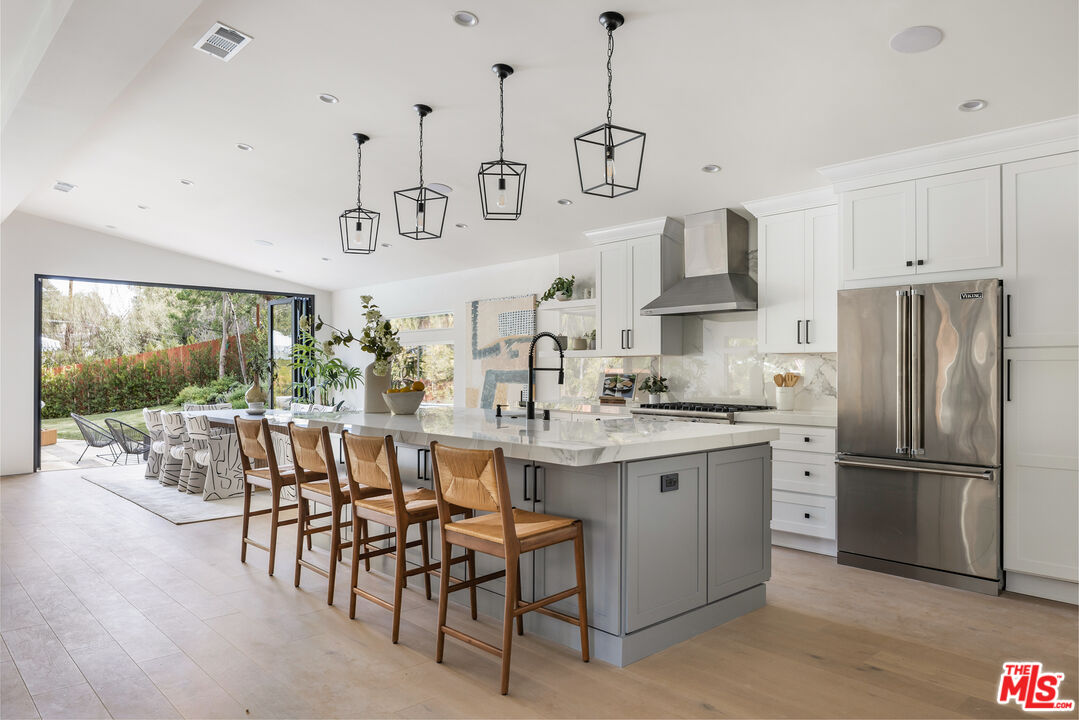 17140 Rancho Street Encino, CA 91316 - Photo 9 of 28 a kitchen with stainless steel appliances granite countertop a stove a sink a refrigerator and a refrigerator