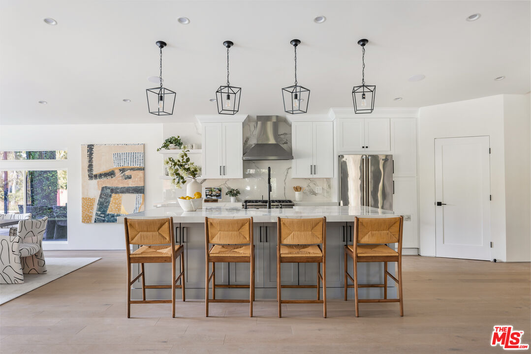 17140 Rancho Street Encino, CA 91316 - Photo 10 of 28 a dining room with furniture and wooden floor