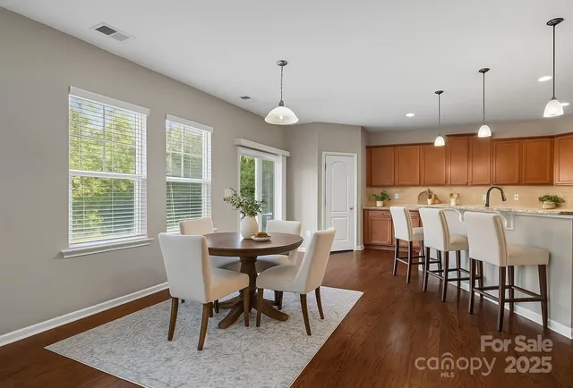 a dining room with furniture window and wooden floor