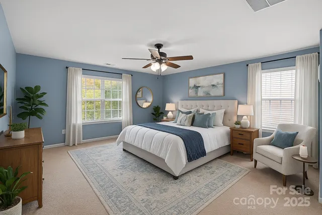 a spacious bedroom with a bed and ceiling fan
