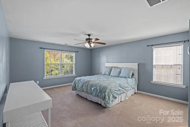 a spacious bedroom with a bed and a window