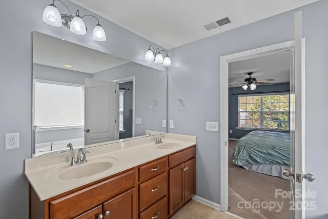 a en suite bathroom with double sink and a mirror