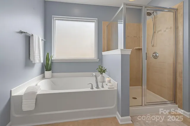 a bathroom with a bathtub and shower