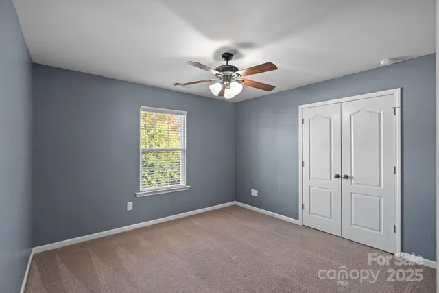 a bathroom with a granite countertop sink toilet mirror and shower