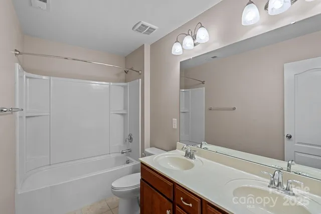 a view of a hallway with wooden floor and stairs