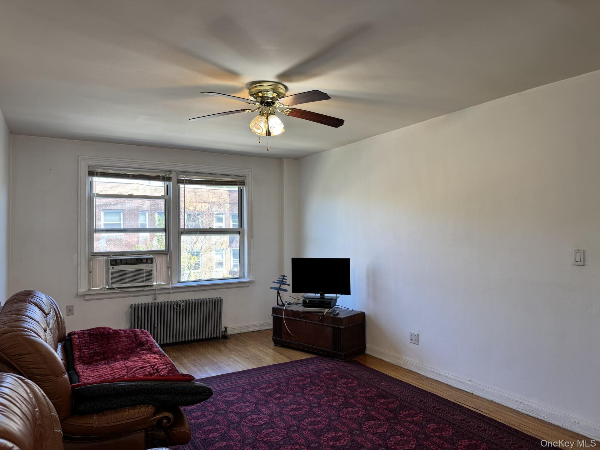141-24 78th Road, Unit 3A Queens, NY 11367 - Photo 5 of 18 a living room with furniture and a window