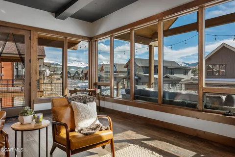 a living room with furniture ceiling fan and a large window