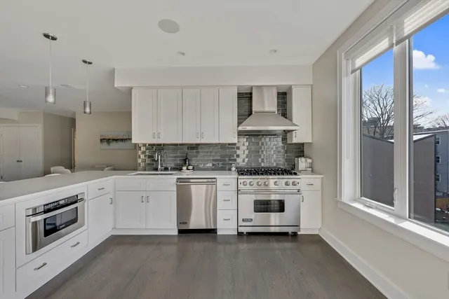 a kitchen with stainless steel appliances granite countertop a stove and a sink