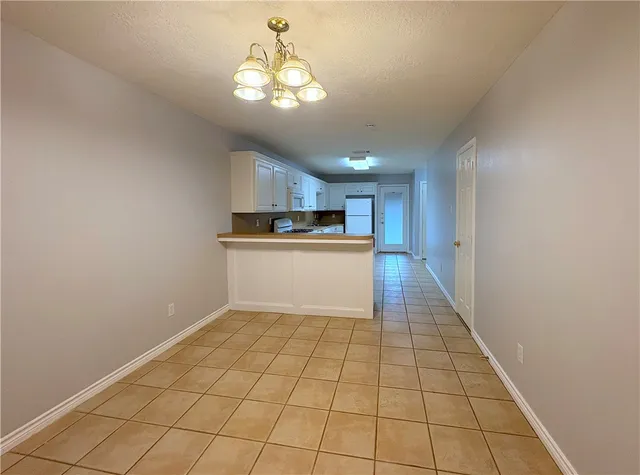 a view of a kitchen with a sink and cabinets