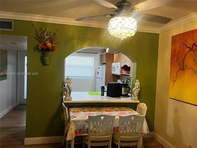 a view of a dining room with furniture and chandelier
