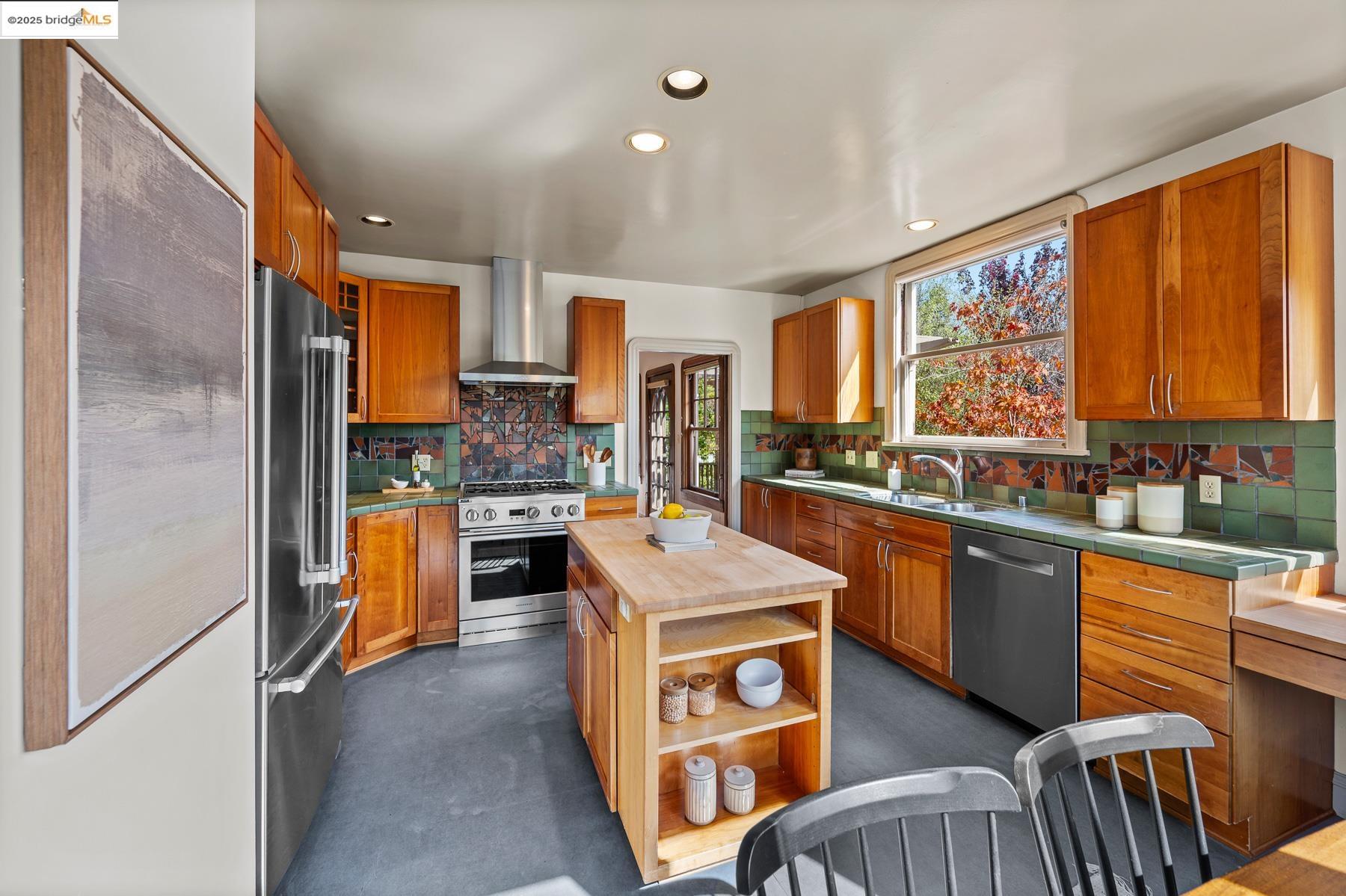 1614 Posen Avenue Berkeley, CA 94707 - Photo 23 of 60 a kitchen with stainless steel appliances kitchen island granite countertop a stove top oven a sink dishwasher and cabinets with wooden floor
