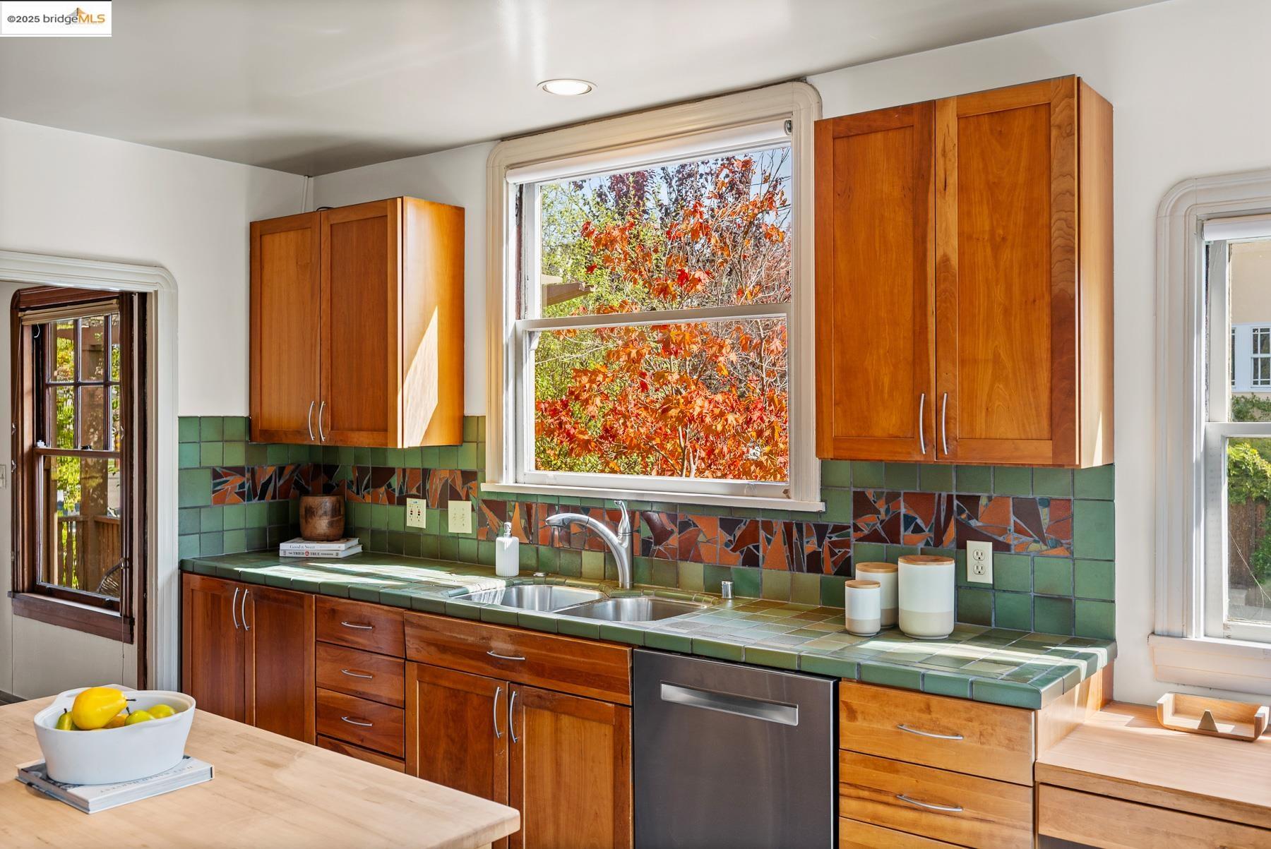1614 Posen Avenue Berkeley, CA 94707 - Photo 24 of 60 a kitchen with stainless steel appliances a sink window and cabinets
