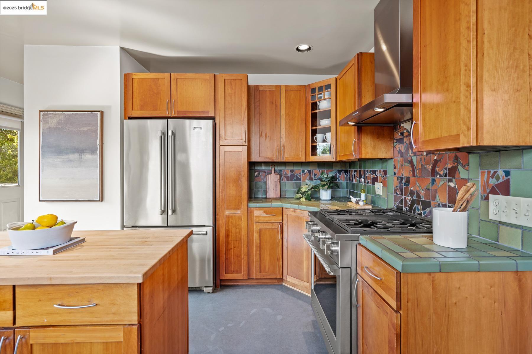1614 Posen Avenue Berkeley, CA 94707 - Photo 27 of 60 a kitchen with stainless steel appliances granite countertop a stove a sink and a refrigerator