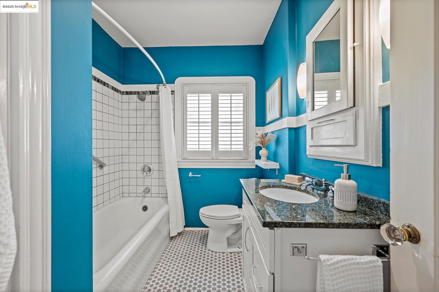 1614 Posen Avenue Berkeley, CA 94707 - Photo 35 of 60 a bathroom with a granite countertop sink a toilet a mirror and bathtub