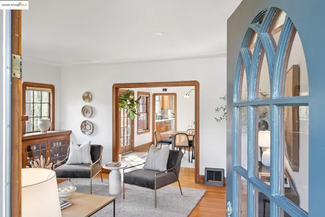 a living room with furniture a window and potted plants