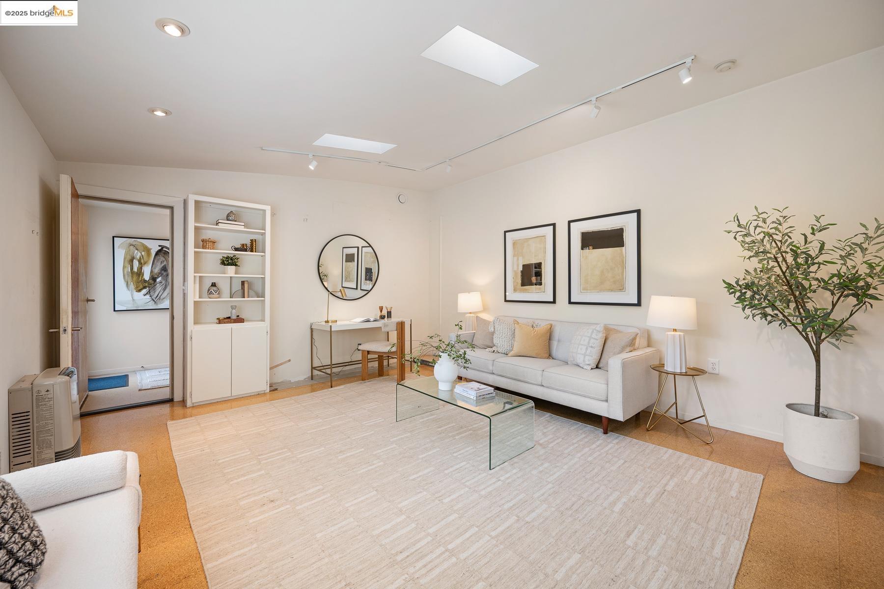1614 Posen Avenue Berkeley, CA 94707 - Photo 52 of 60 a living room with furniture a clock and a large window