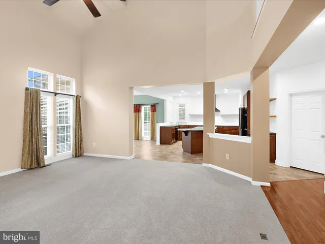 a large kitchen with a sink and large window